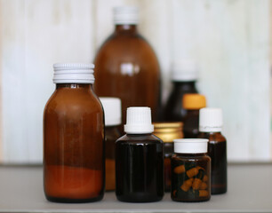 brown bottle with cough syrup on background