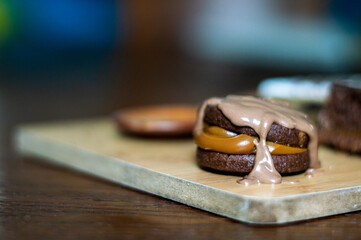 Uruguayan and Argentinian alfajor in dark scenery. Typical South American food. Chocolate cake with dulce de leche filling. Uruguay. Argentina