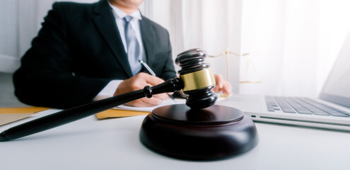 Business and lawyers discussing contract papers with brass scale on desk in office. Law, legal services, advice, justice and law concept picture with film grain effect