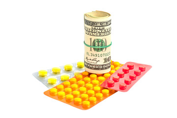 Medicines and dollars isolated on white background.