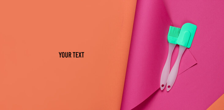 Kitchen tools on a colored paper background with space for yout text. Minimalistic cooking still life. Pastel color trend