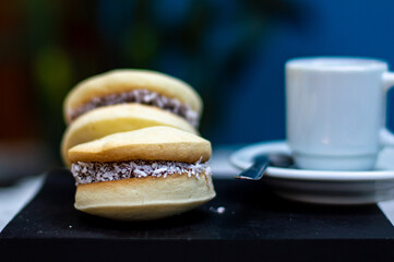 Uruguayan and Argentinian alfajor in dark scenery. Typical South American food. Chocolate cake with dulce de leche filling. Uruguay. Argentina