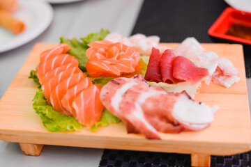 Japan of raw fresh fish fillet, sashimi mix salmon and tuna set on wooden board