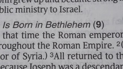 Luke 2 - Christmas story from Bible in book of Luke pan very close on white background for Christian Christmas encouragement from the New Testament Bible scriptures.	