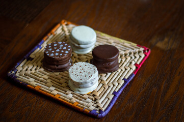 Uruguayan and Argentinian alfajor in dark scenery. Typical South American food. Chocolate cake with dulce de leche filling. Uruguay. Argentina