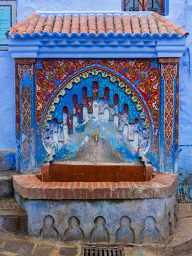 Colorful fountain with mosaic tiles in medina of Chefchaouen town, Morocco