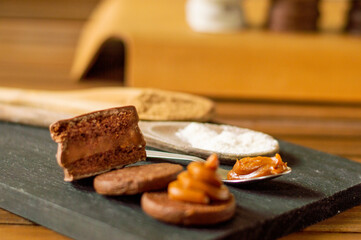 Uruguayan and Argentinian alfajor in dark scenery. Typical South American food. Chocolate cake with dulce de leche filling. Uruguay. Argentina