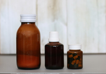 brown bottle with cough syrup on background