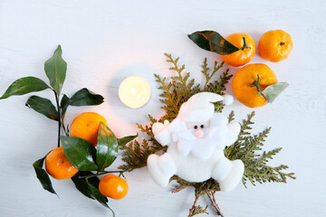 New Year's decorative attributes 2022, Santa Claus is white, tangerines are fresh. Holiday concept,...