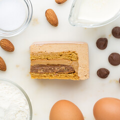Slice of milk chocolate mousse cake. Top view. Slice filling in section on a marble dek.