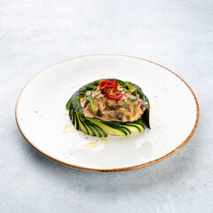 Meat stew with vegetables and herbs on white background.