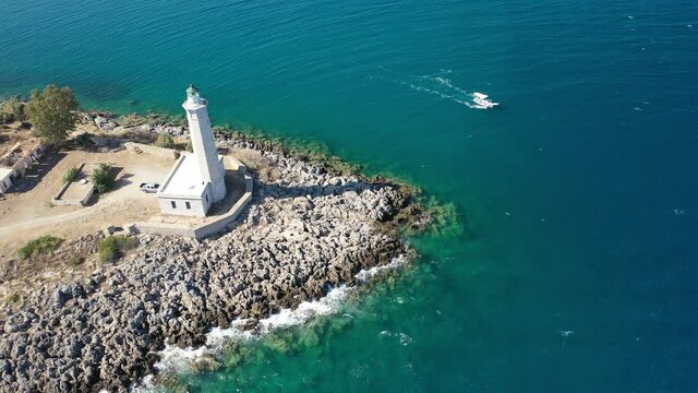 Aerial drone video of famous small islet of Kranai known for old lighthouse and tower of Tzannetakis, Gytheio, Lakonia, Peloponnese, Greece