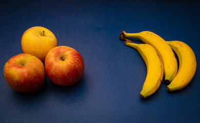 Apples and bananas in a blue background