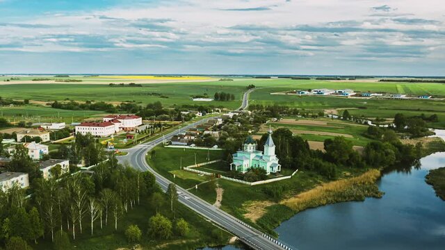 Krupets, Dobrush District, Gomel Region, Belarus. Aerial View Of Old Wooden Orthodox Church Of The Holy Trinity At Sunny Summer Evening. Drone Hyper lapse