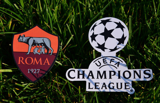 September 6, 2019 Istanbul, Turkey. The emblem of the Italian football club Roma Rome next to the logo of the Champions League on the green grass of the football field.