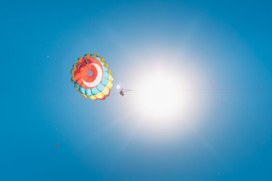 A vacationer rides on a parachute tied with a rope to a boat or boat. Water activities and entertainment as well as sports in Turkey concept