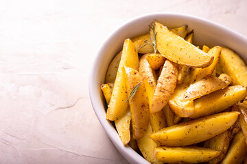 Delicious slices of baked potatoes with rosemary and oil.
