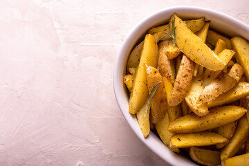 Slices of baked potatoes with rosemary and oil