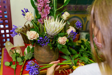 entrepreneur woman working in the flower shop after being able to reopen