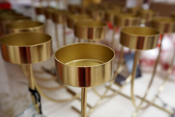 many small round metal candlesticks are sold in the supermarket
