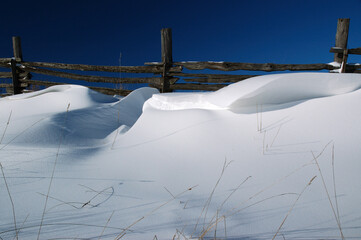 Blue sky with cedar fence and snow drift cornice