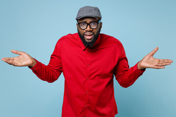 Confused puzzled young bearded african american man 20s wearing casual red shirt eyeglasses cap...