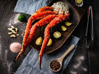Fresh red king crab crab claws with lemon slices and spices . Tasty kamchatka crab's claw © Adsloboda