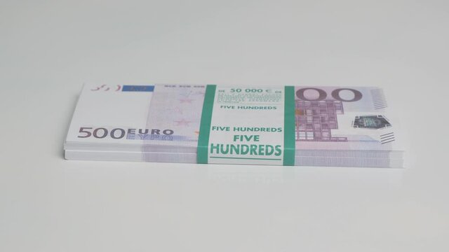 bundle of five hundred euro bills on white background.