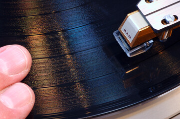 Scratching vinyl record with tone arm