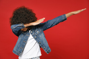 Llittle african american kid girl 12-13 years old in denim jacket doing dab hip hop dance hands...
