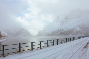 landscape with mountains, fog and lake