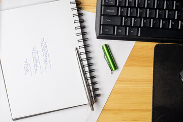 Notebook and laptop on old wooden desk