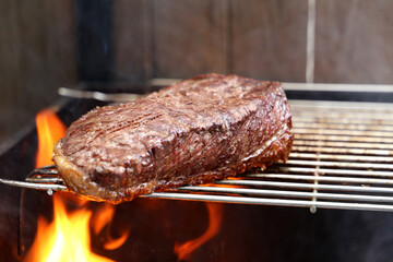 Picanha. Traditional Brazilian barbecue with steak in background. 