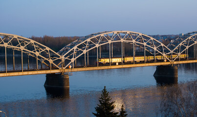 Electric train passing the bridge over Daugava in Riga
