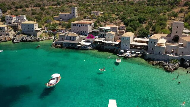 Aerial drone video of beautiful small seaside village of Limeni with emerald clear sea, Mani Peninsula, Lakonia, Peloponnese, Greece
