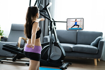 Fototapeta na wymiar Woman Training Using Online Video Exercise