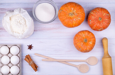 Top view, flat lay kitchen utensils and ingredients for cooking pumpkin pie. Copy space, selective focus.