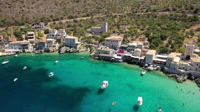 Aerial drone video of beautiful small seaside village of Limeni with emerald clear sea, Mani Peninsula, Lakonia, Peloponnese, Greece