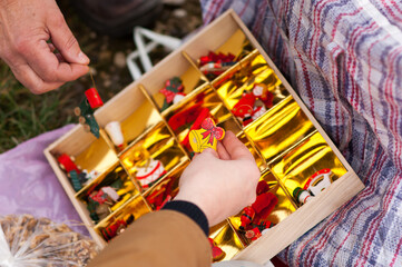 Beautiful second hand decorations for the Christmas tree in female hands