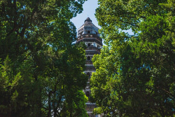 Tiger Hill Pagoda (Pagoda of Yunyan Temple) behind trees on Tiger Hill (Huqiu) in Suzhou, Jiangsu, China