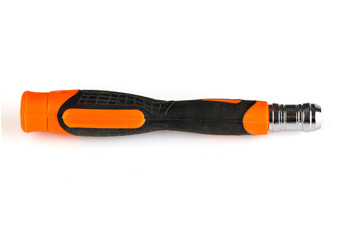 Screwdriver handle with replaceable bits. Orange plastic handle covered with rubber. Isolated on white background. Close-up.