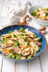Mushroom pasta salad with steamed broccoli and baked chicken meat slices