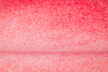 Blurred abstract holiday background. Gold design with glitter red background, bright sparkle bokeh texture for xmas shine silver pattern. Celebratory, luxury party concept.