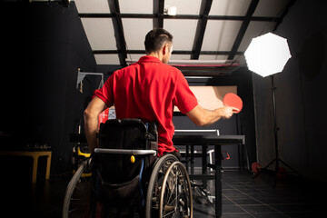 Fototapeta na wymiar Wheelchair user playing table tennis