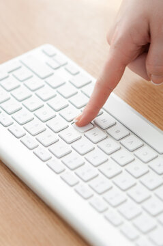 Female Finger Pressing Key On A Keyboard