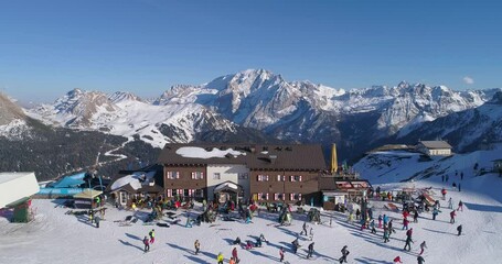 Aerial above ski resort with people partying and dancing in snow at the Ski resorts Dolomites