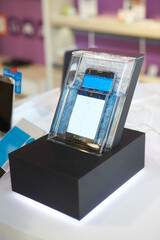 A sleek, modern smartphone inside box with water. waterproof construction
