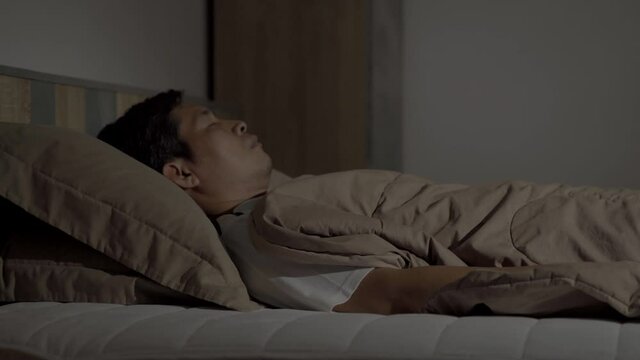 Close up, Man sleeping on bed in bedroom at home
