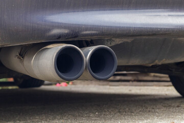 Twin exhaust pipes with black sooty deposites from diesel fuel