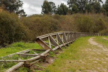 Wooden railing damaged by storms and vandals in a park in Galicia Spain